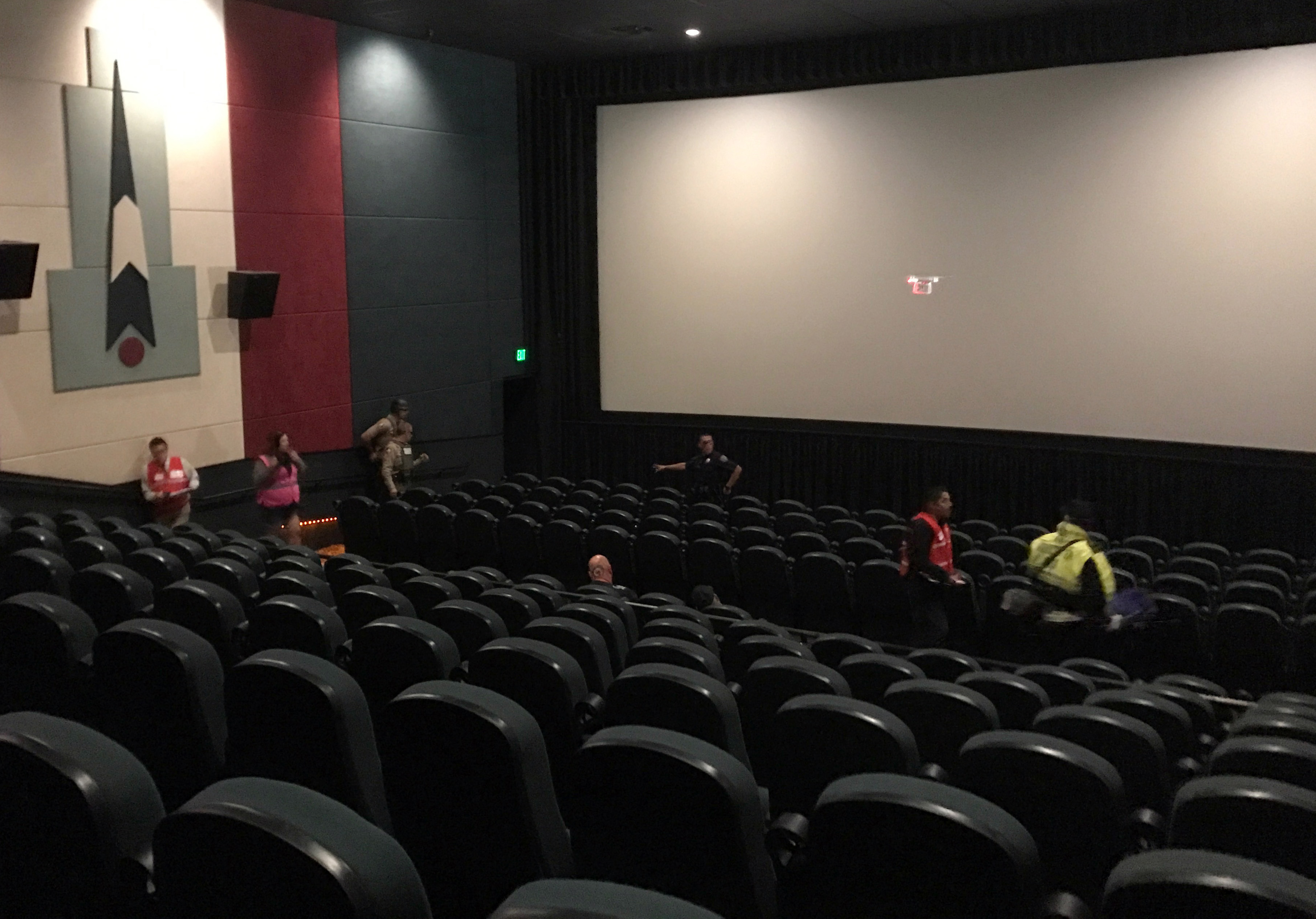 A drone flies in front of the movie screen during the active shooter drill at Premiere Cinemas in Hollister.